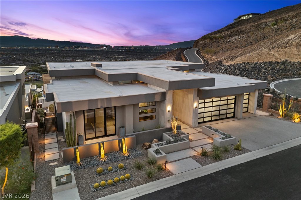 657 Ridgestone Rim Court Henderson, NV 89012 - Photo 2 of 97 Bold geometric lines and integrated stone textures define this modern desert facade.