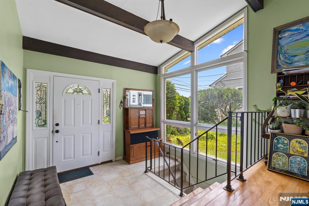 8 Hampton Road Clifton, NJ 07012 - Photo 2 of 16 a view of a hallway with wooden floor and windows
