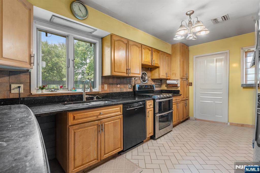 8 Hampton Road Clifton, NJ 07012 - Photo 7 of 16 a kitchen with a sink stove and cabinets