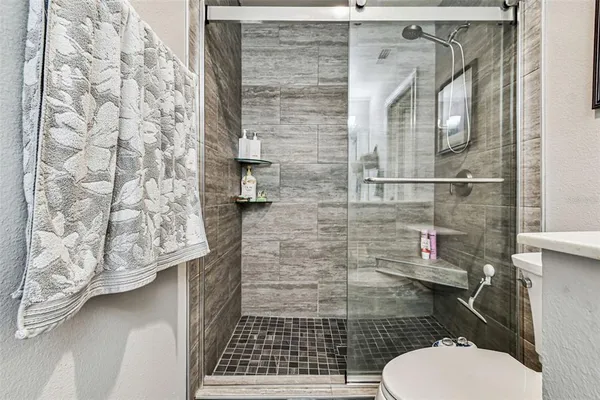 a bathroom with a toilet and a shower