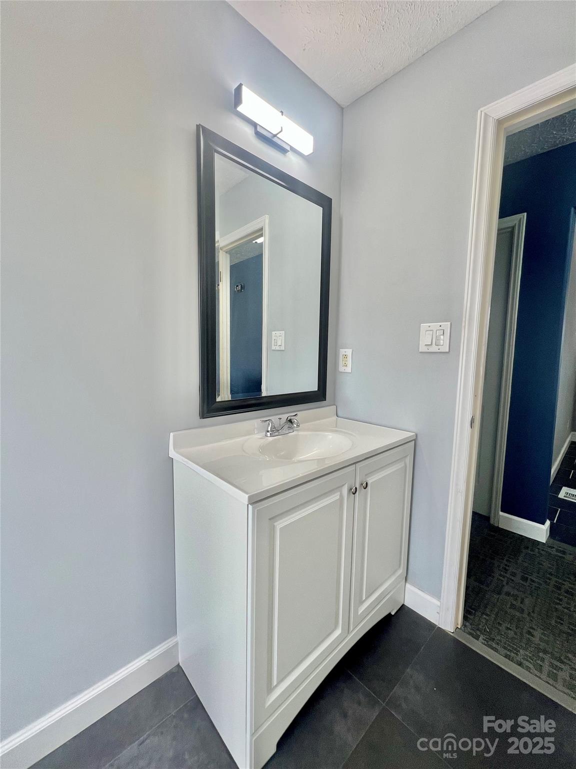 1182 Village Circle Hickory, NC 28602 - Photo 12 of 24 a bathroom with a granite countertop sink and a mirror