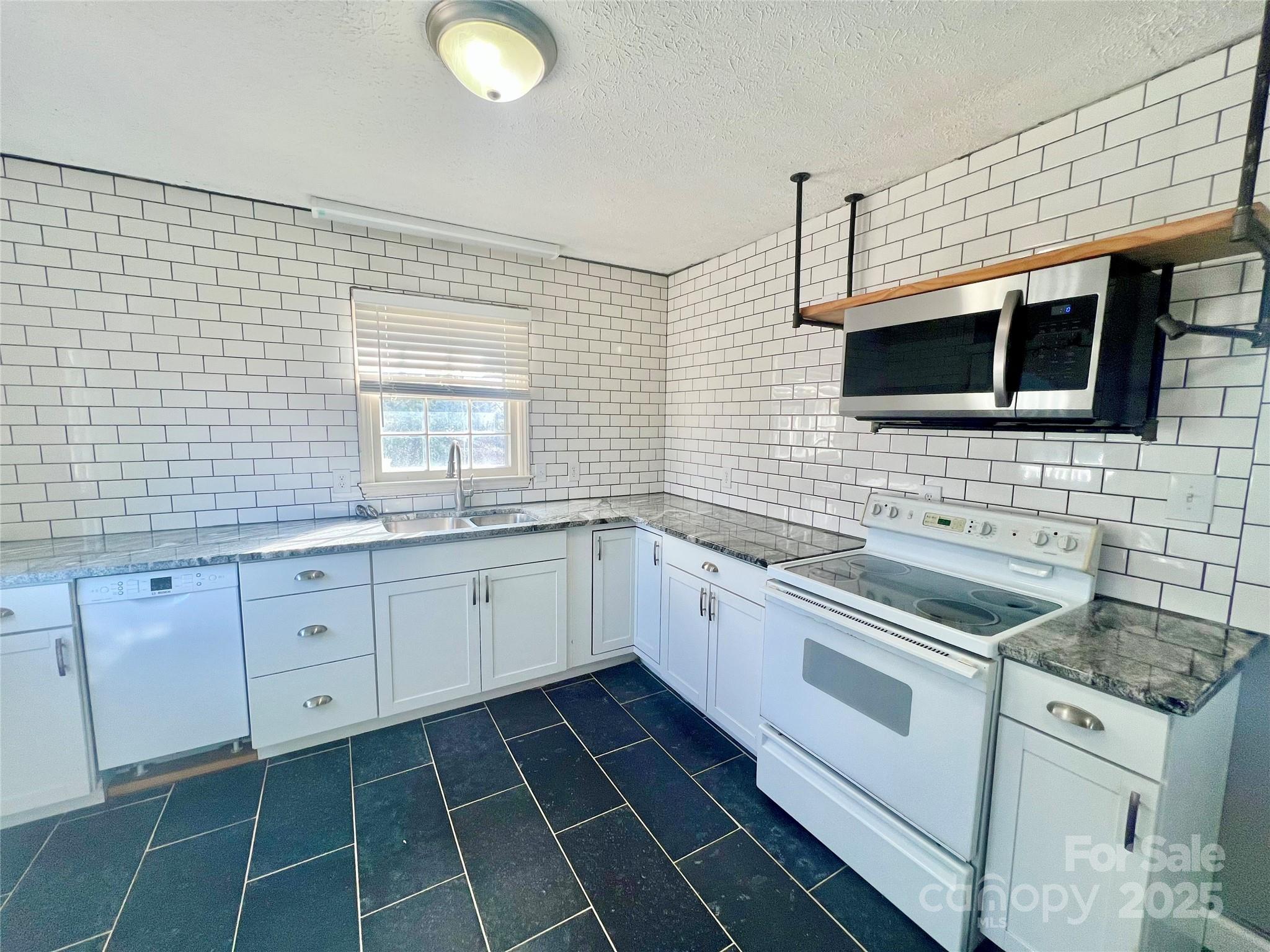1182 Village Circle Hickory, NC 28602 - Photo 3 of 24 a kitchen with a sink stove and cabinets