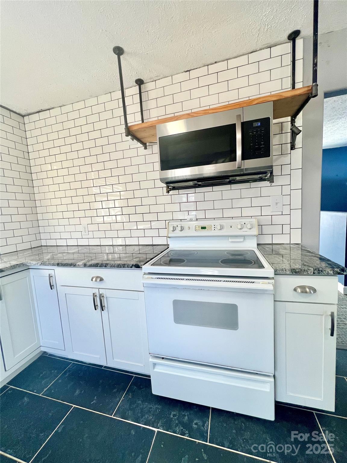 1182 Village Circle Hickory, NC 28602 - Photo 4 of 24 a kitchen with a stove microwave and cabinets