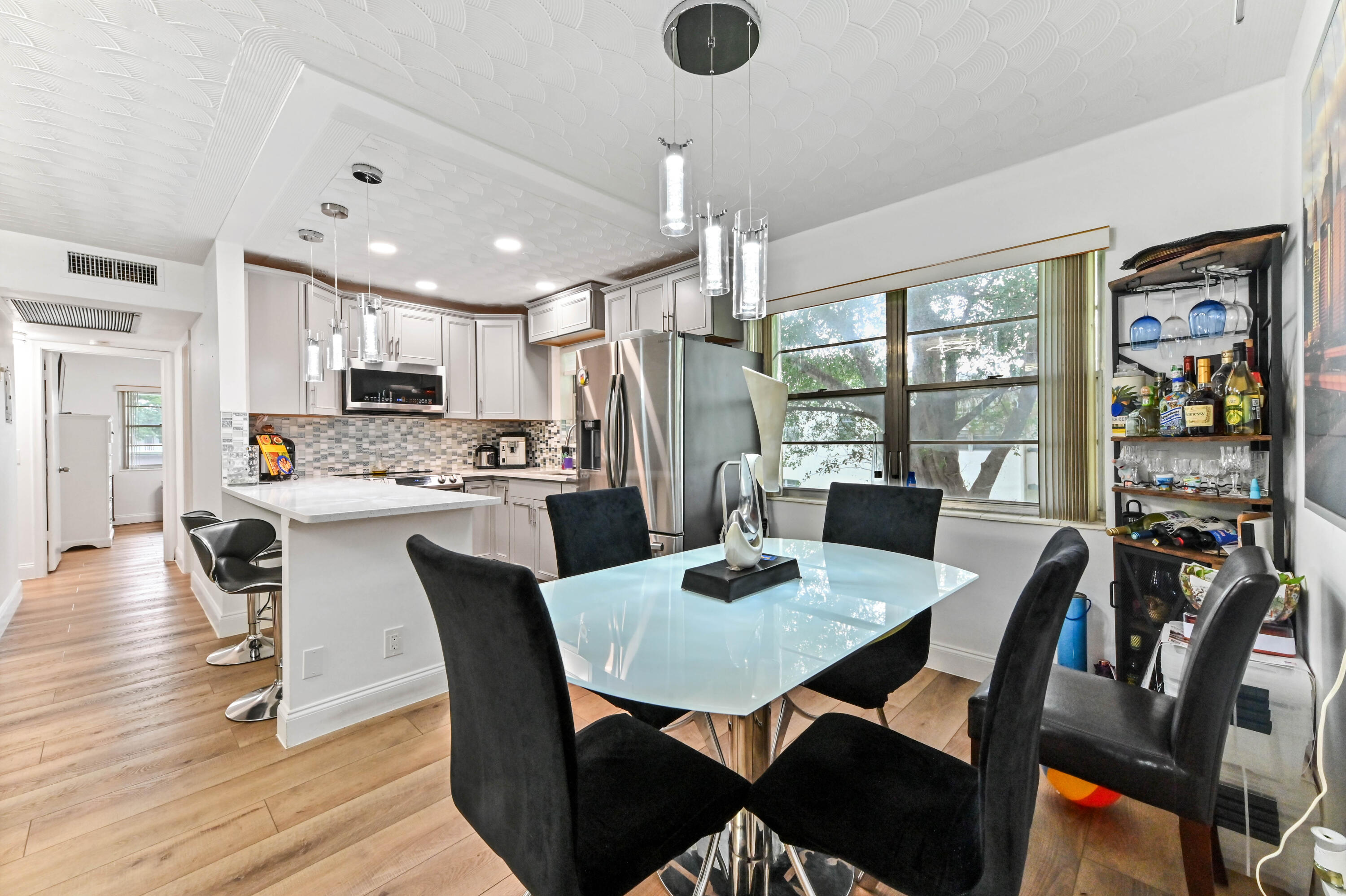 204 Ellesmere D Deerfield Beach, FL 33442 - Photo 6 of 46 a view of a dining room with furniture window and wooden floor