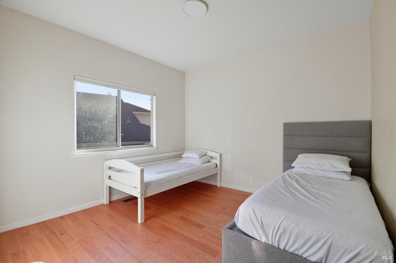 5828 Owl Hill Avenue Santa Rosa, CA 95409 - Photo 22 of 39 a bedroom with a bed and a window