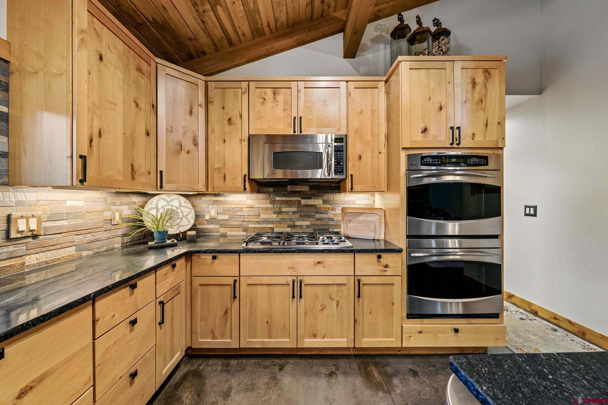24 Monarch Crest Trail Durango, CO 81301 - Photo 14 of 45 a kitchen with stainless steel appliances granite countertop a stove a sink and a microwave