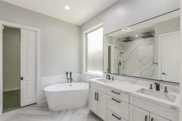 a bathroom with a double vanity sink mirror double and shower