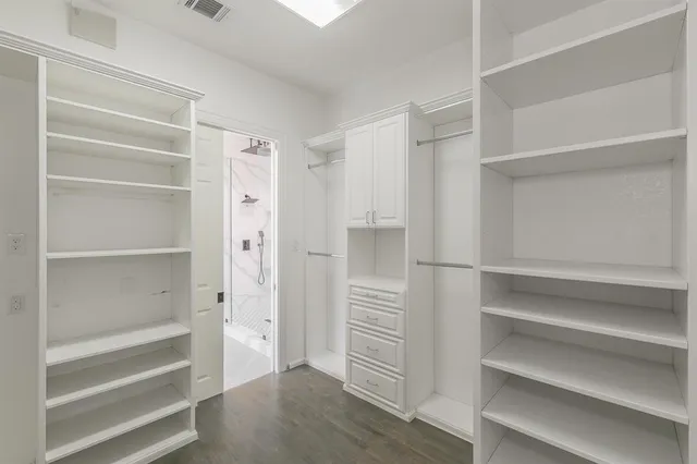 a view of walk in closet with empty racks