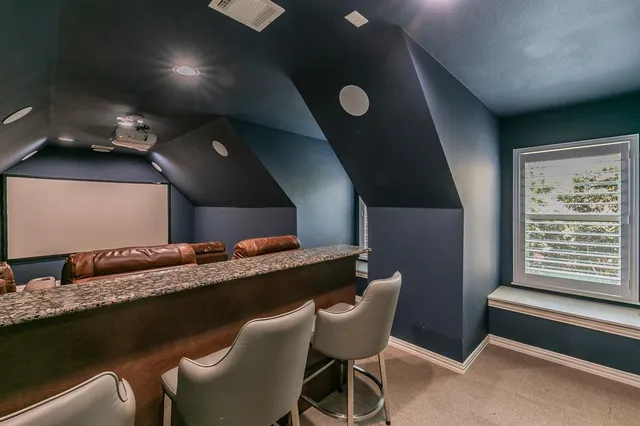 a dining room with furniture and a floor to ceiling window