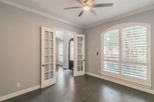 a view of a livingroom with wooden floor and a ceiling fan