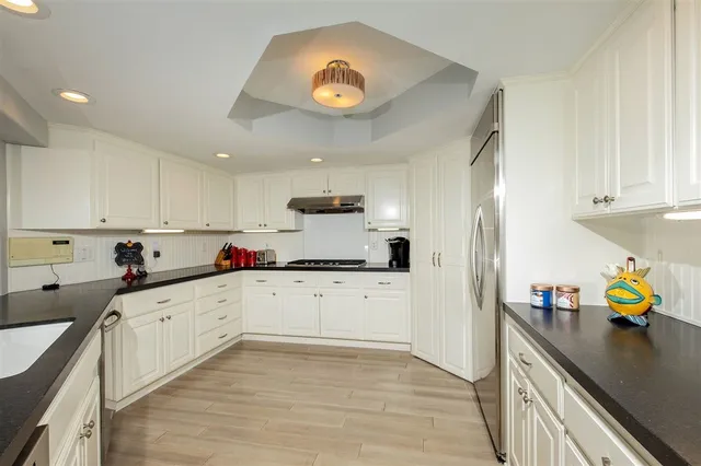 a kitchen with a sink appliances and cabinets