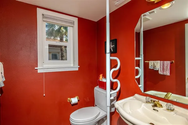 a bathroom with a toilet sink and mirror