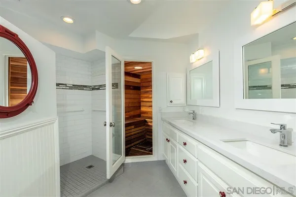 a bathroom with a sink double vanity and a shower