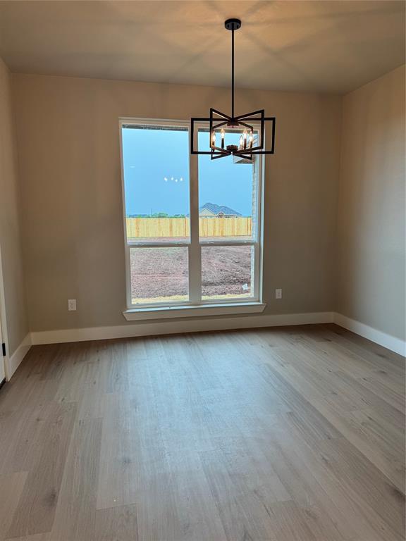 143 Ridge Road Tuscola, TX 79562 - Photo 9 of 24 a view of empty room with wooden floor and window