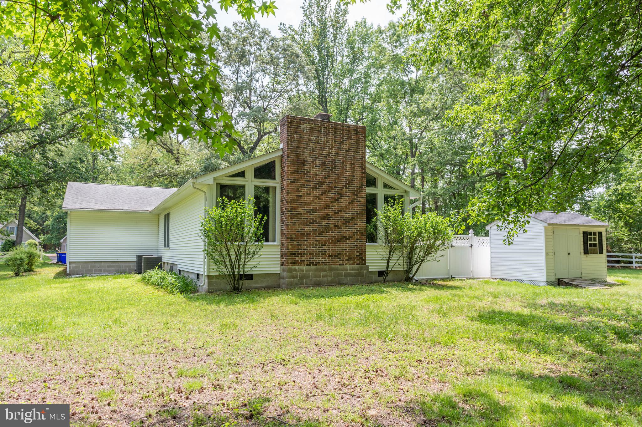 22167 Melson Road Georgetown, DE 19947 - Photo 13 of 38 a view of a backyard with large trees and plants