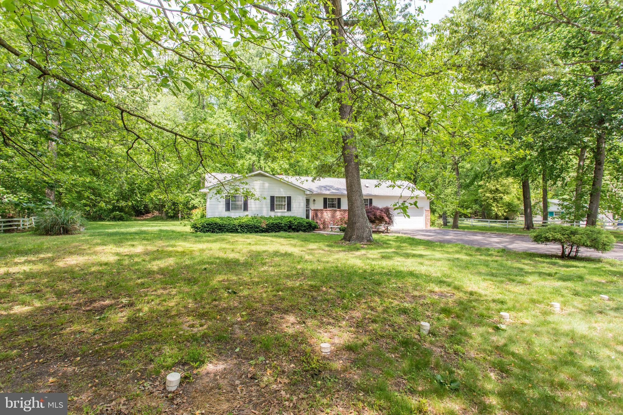 22167 Melson Road Georgetown, DE 19947 - Photo 14 of 38 a front view of a house with garden