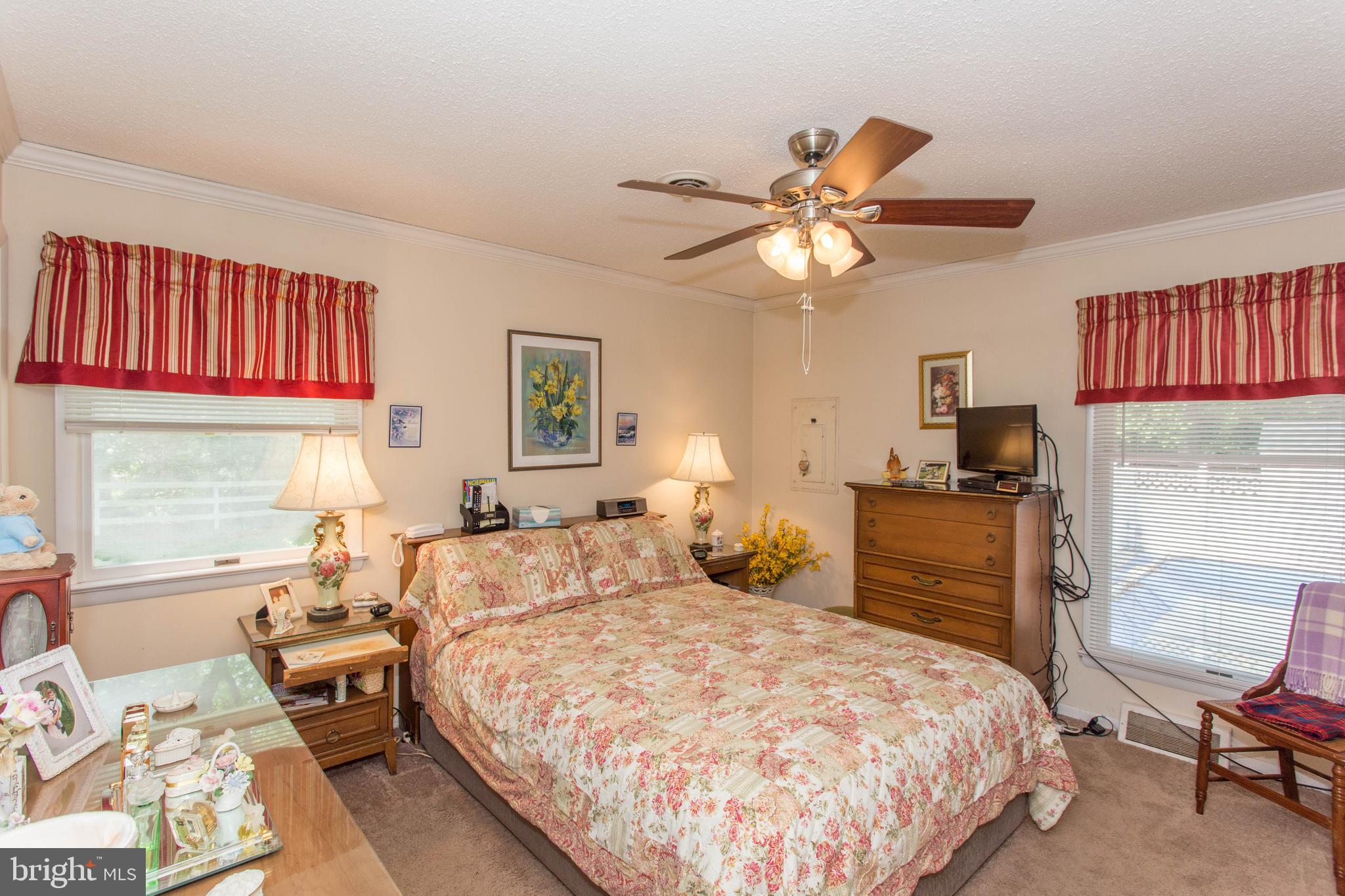 22167 Melson Road Georgetown, DE 19947 - Photo 22 of 38 a bedroom with a bed and a chandelier