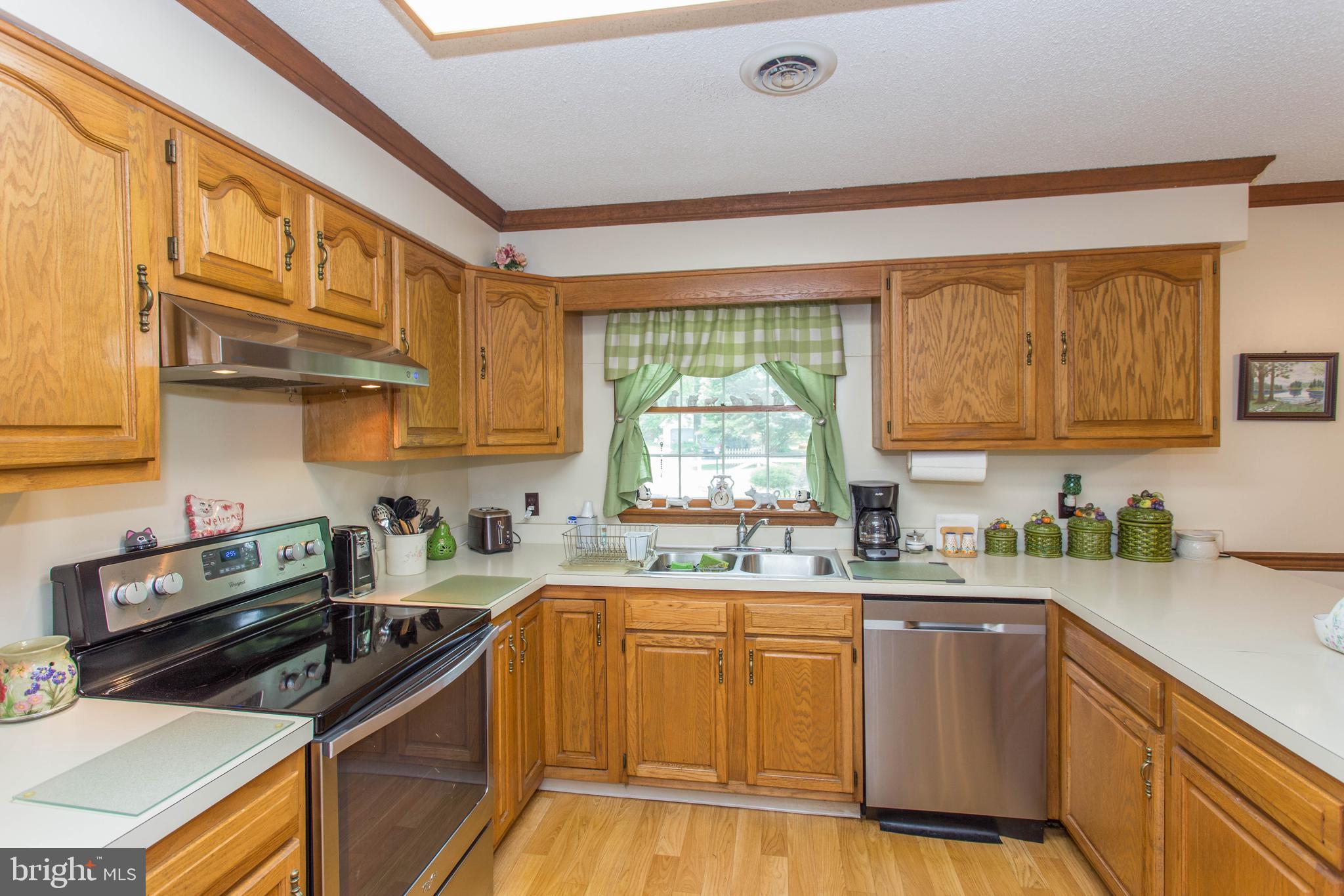 22167 Melson Road Georgetown, DE 19947 - Photo 26 of 38 a kitchen with stainless steel appliances a sink a stove and cabinets