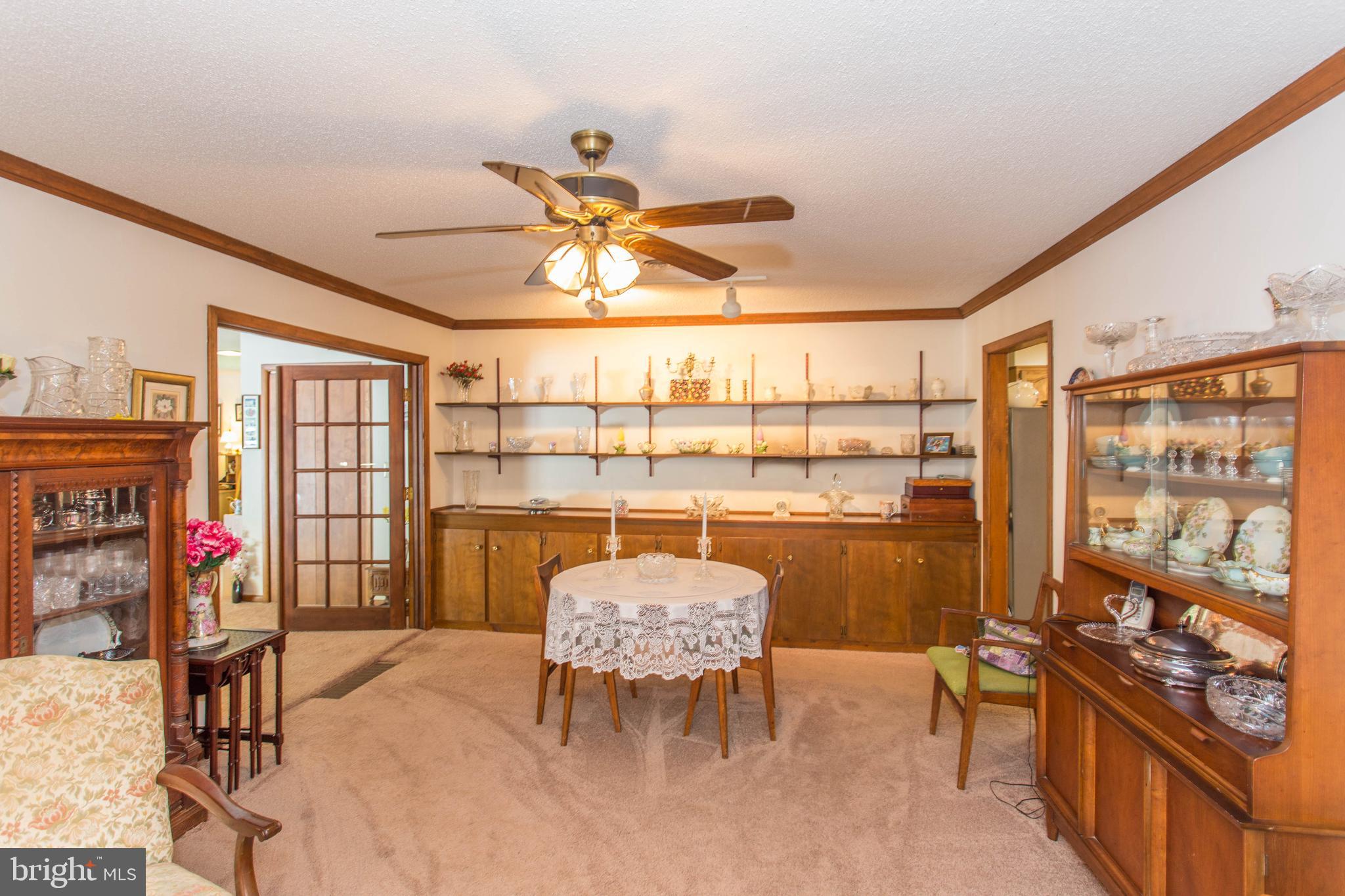22167 Melson Road Georgetown, DE 19947 - Photo 28 of 38 a view of a dining room with furniture and chandelier