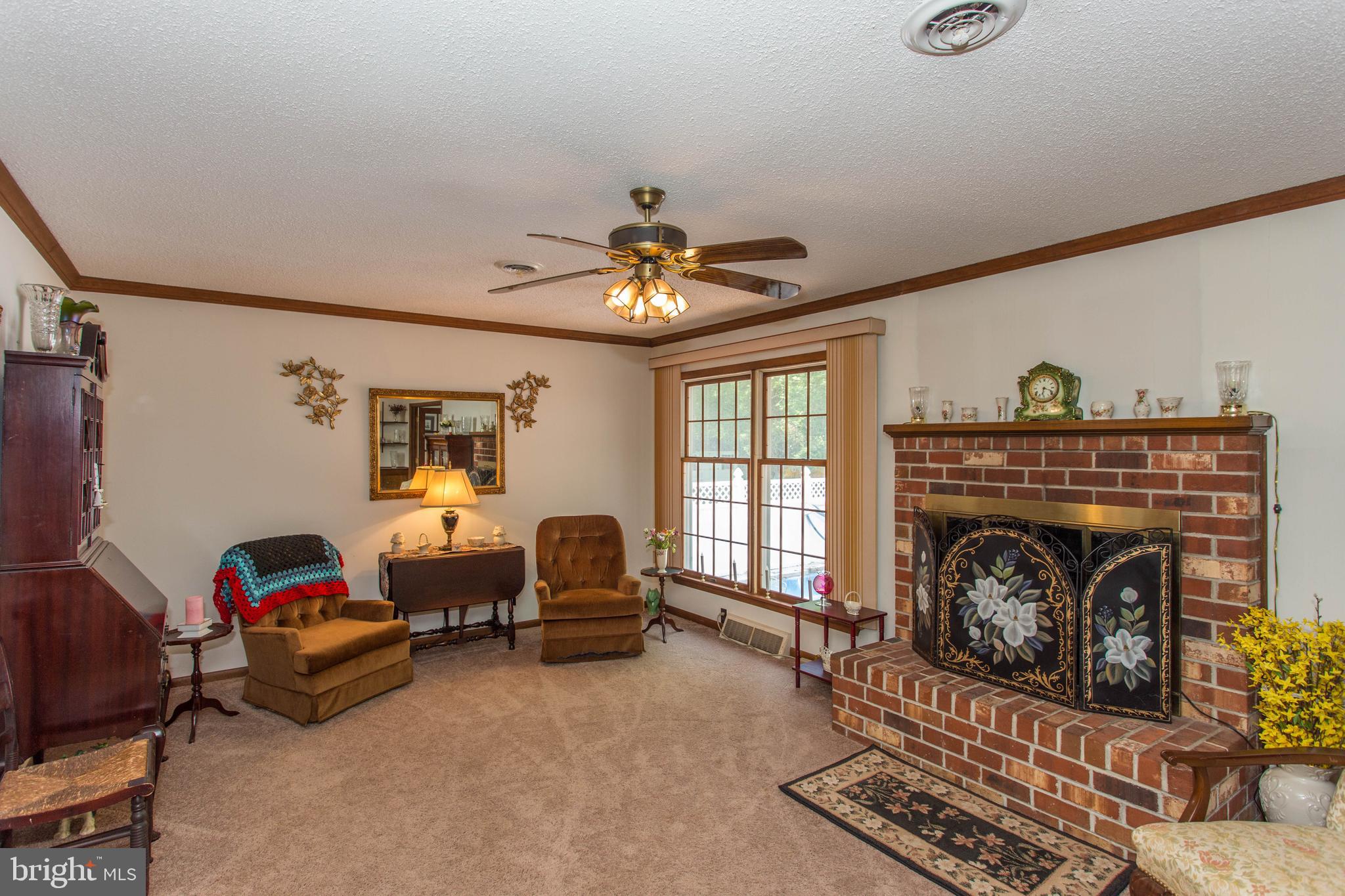 22167 Melson Road Georgetown, DE 19947 - Photo 29 of 38 a living room with furniture and a fireplace
