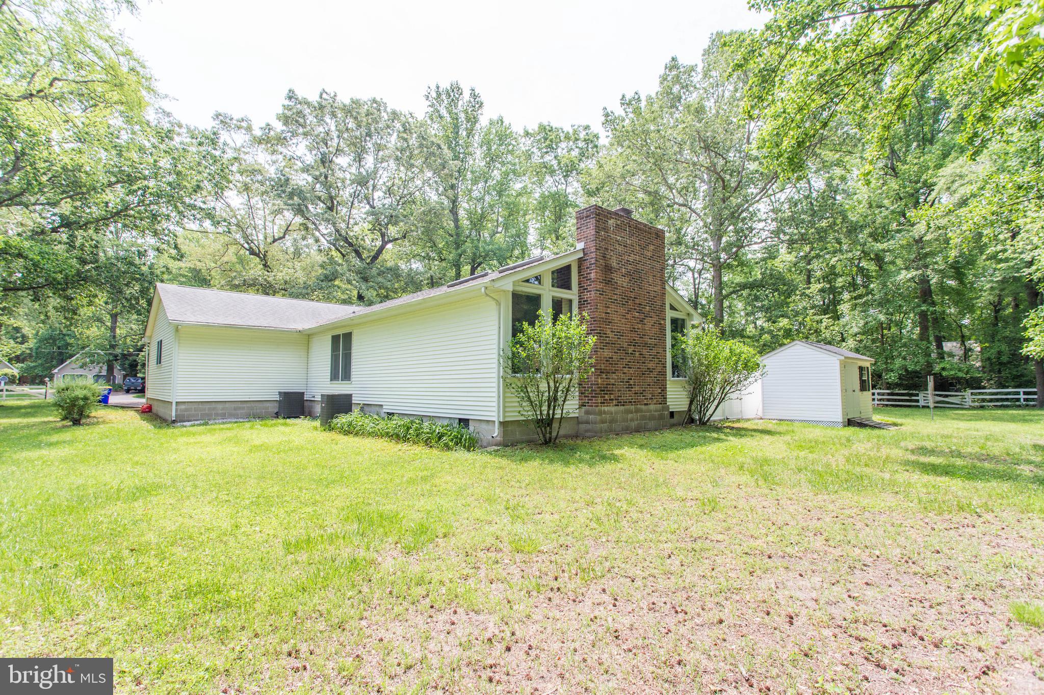 22167 Melson Road Georgetown, DE 19947 - Photo 36 of 38 a backyard of a house with yard and trampoline