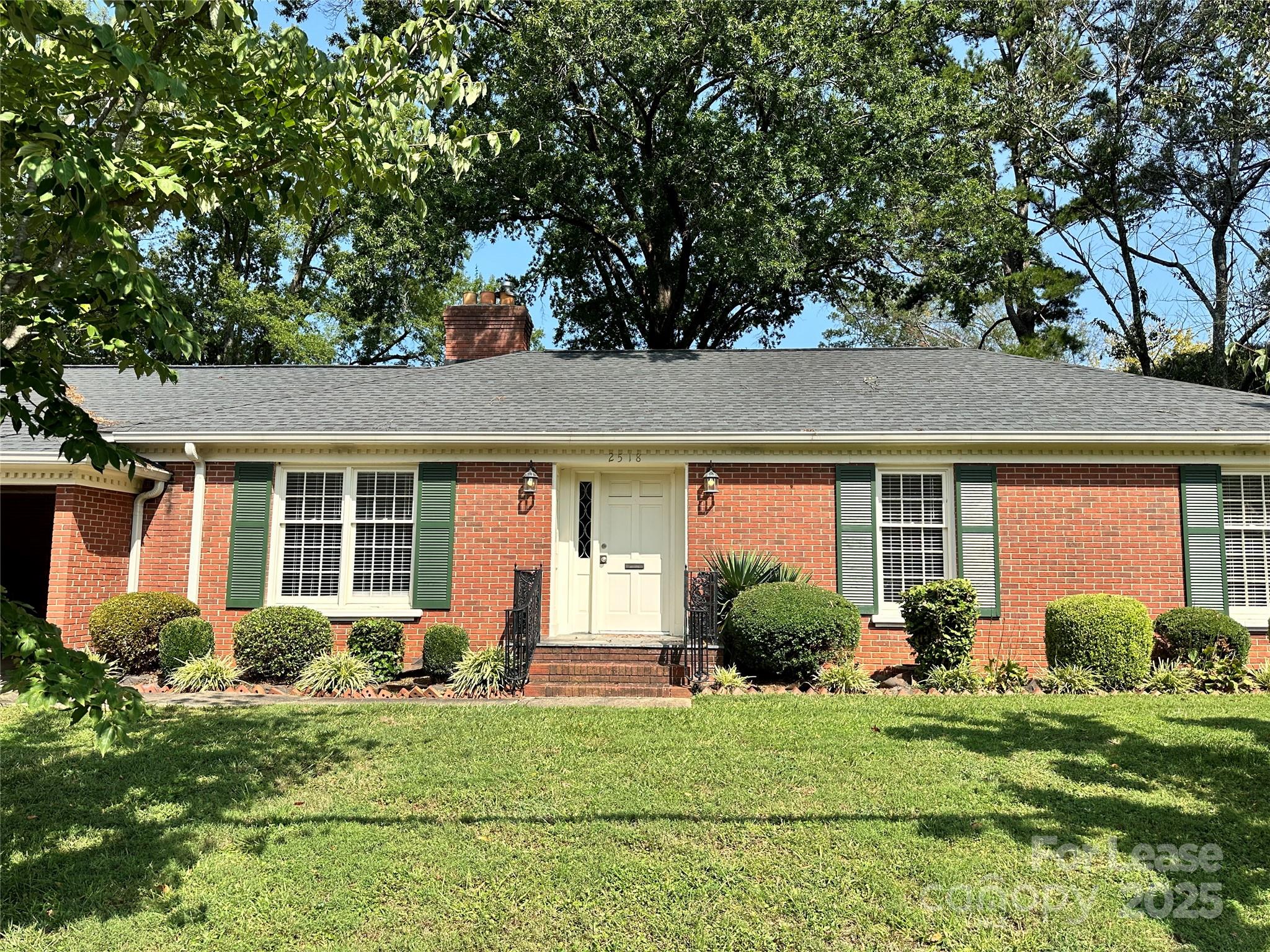 front view of a house with a garden