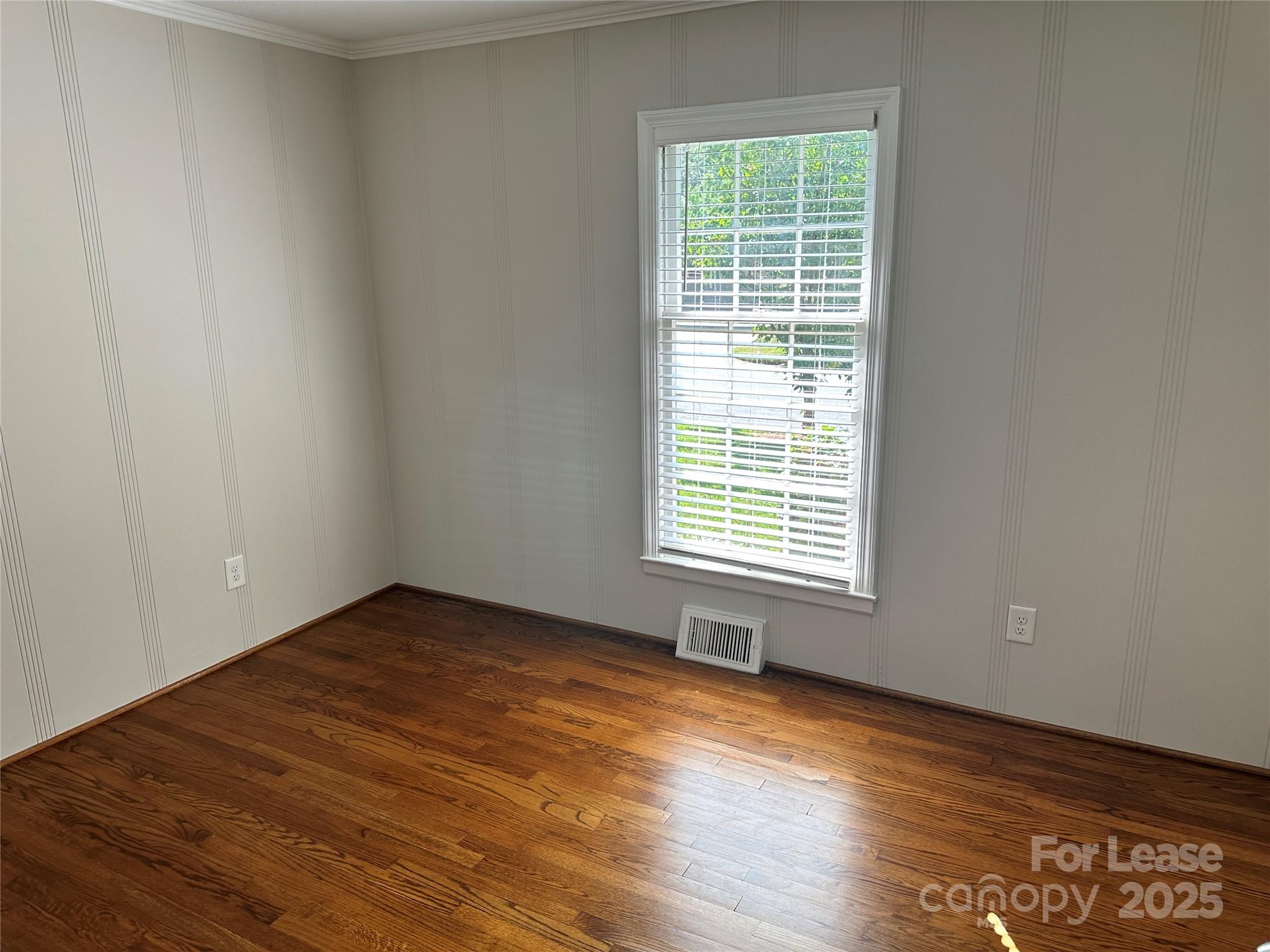 2518 Westfield Road Charlotte, NC 28209 - Photo 11 of 19 a view of an empty room with wooden floor and a window