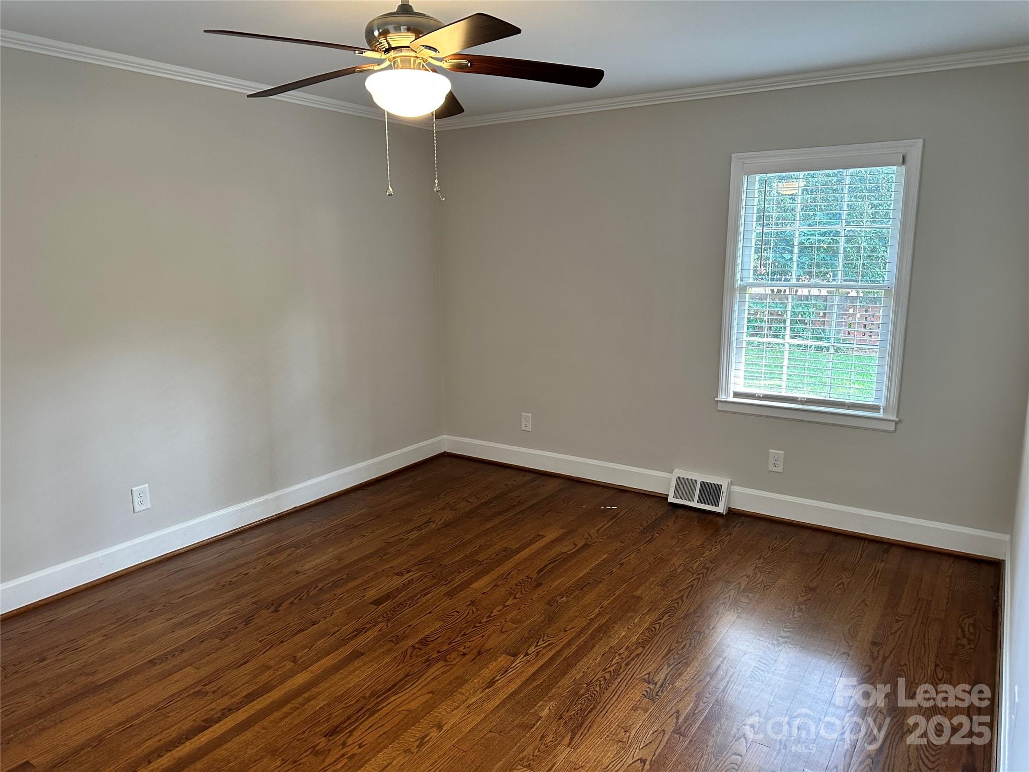 2518 Westfield Road Charlotte, NC 28209 - Photo 13 of 19 an empty room with wooden floor fan and windows