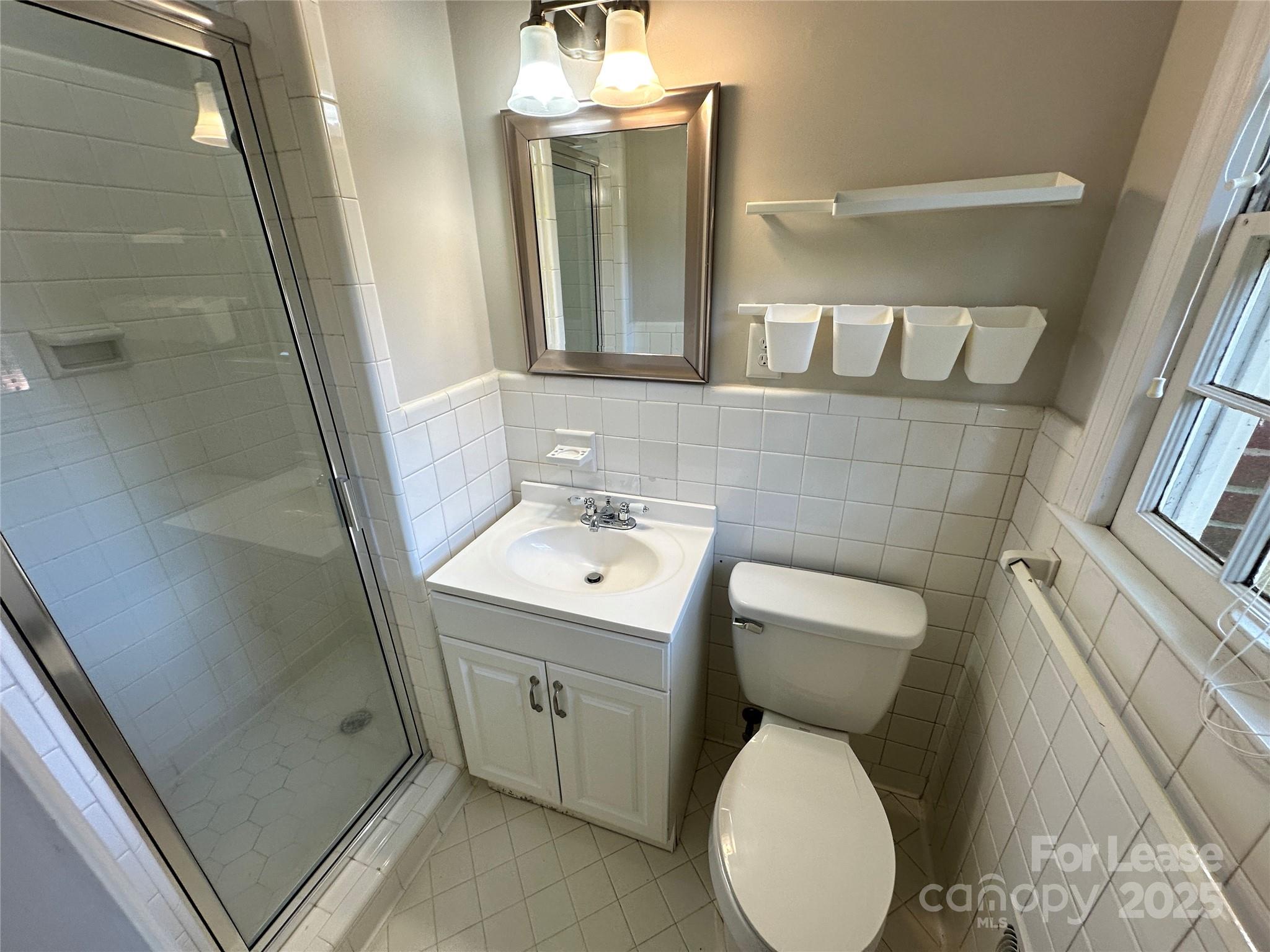 2518 Westfield Road Charlotte, NC 28209 - Photo 14 of 19 a bathroom with a toilet sink and mirror