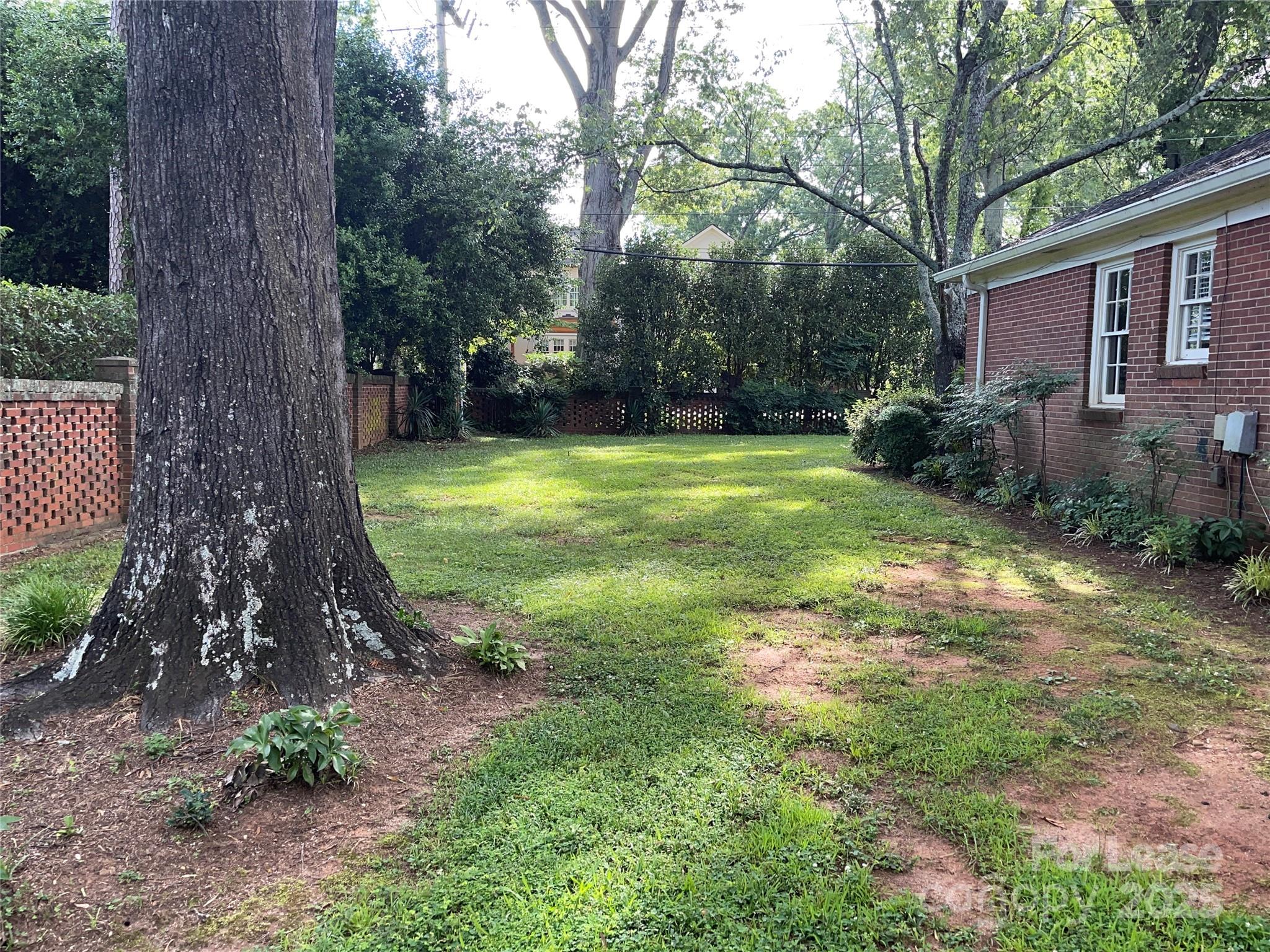 2518 Westfield Road Charlotte, NC 28209 - Photo 17 of 19 a view of a backyard with a trees