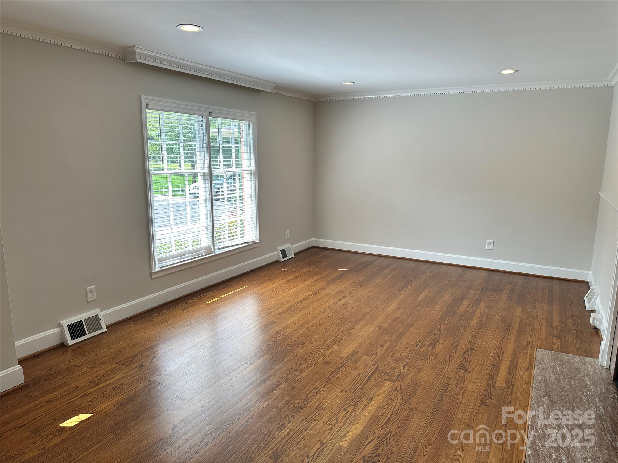 2518 Westfield Road Charlotte, NC 28209 - Photo 5 of 19 an empty room with wooden floor and windows