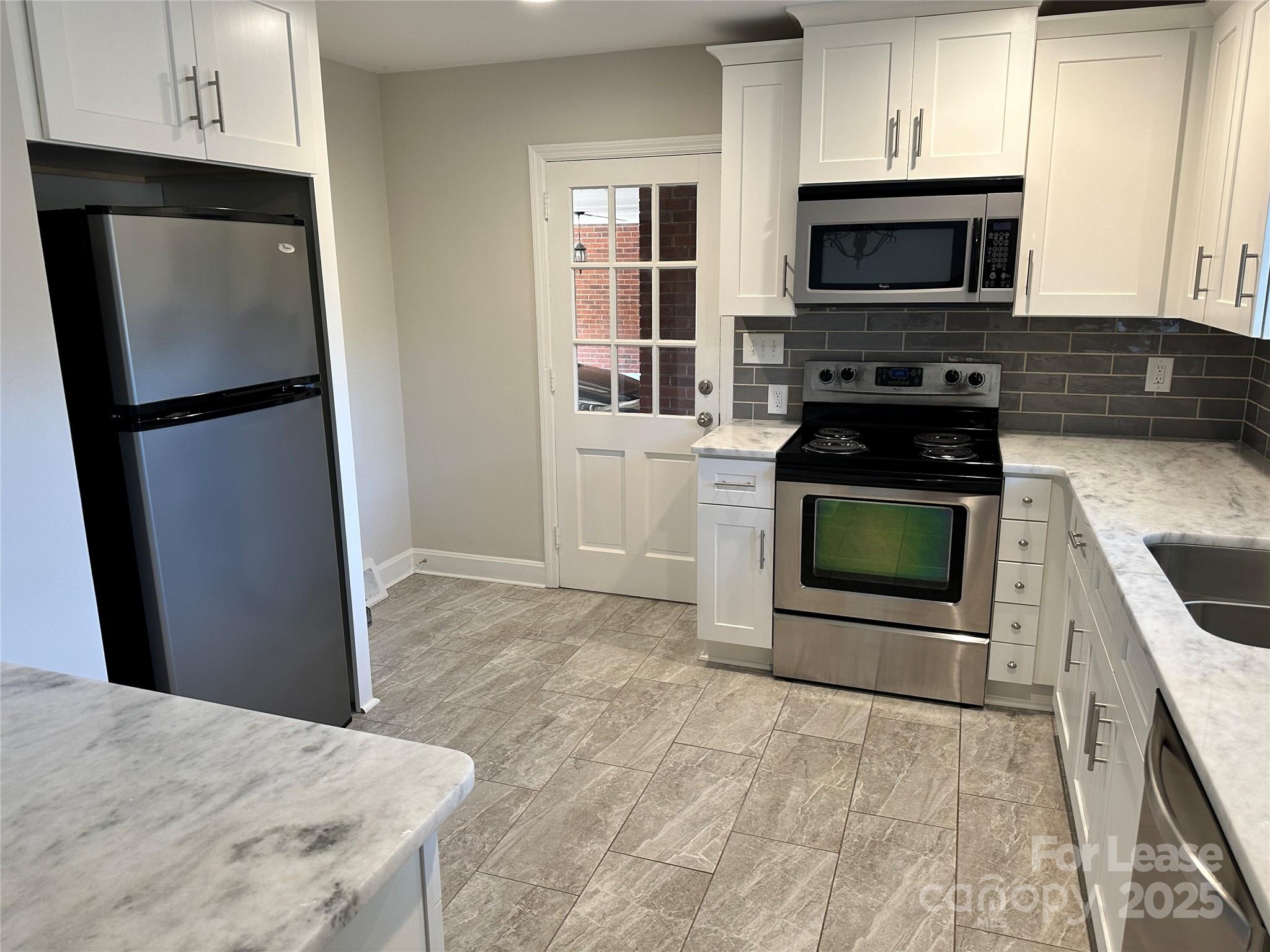 2518 Westfield Road Charlotte, NC 28209 - Photo 9 of 19 a kitchen with a stove microwave and refrigerator