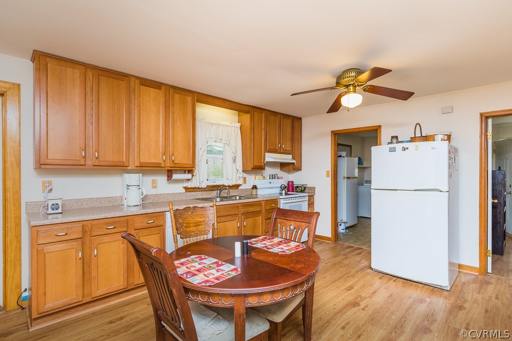 8900 Doss Road Moseley, VA 23120 - Photo 14 of 48 a kitchen with a refrigerator a stove a sink cabinetry and dining table