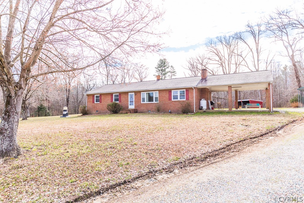 8900 Doss Road Moseley, VA 23120 - Photo 3 of 48 a front view of a house with a yard covered with trees