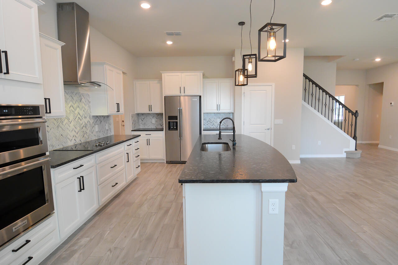 902 Foal Point Oviedo, FL 32765 - Photo 12 of 35 a kitchen with counter top space cabinets and stainless steel appliances