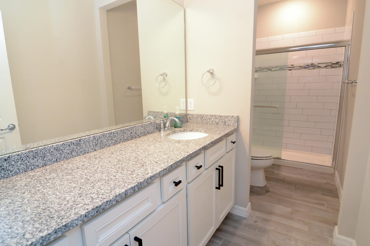 902 Foal Point Oviedo, FL 32765 - Photo 17 of 35 a bathroom with a granite countertop sink and a mirror