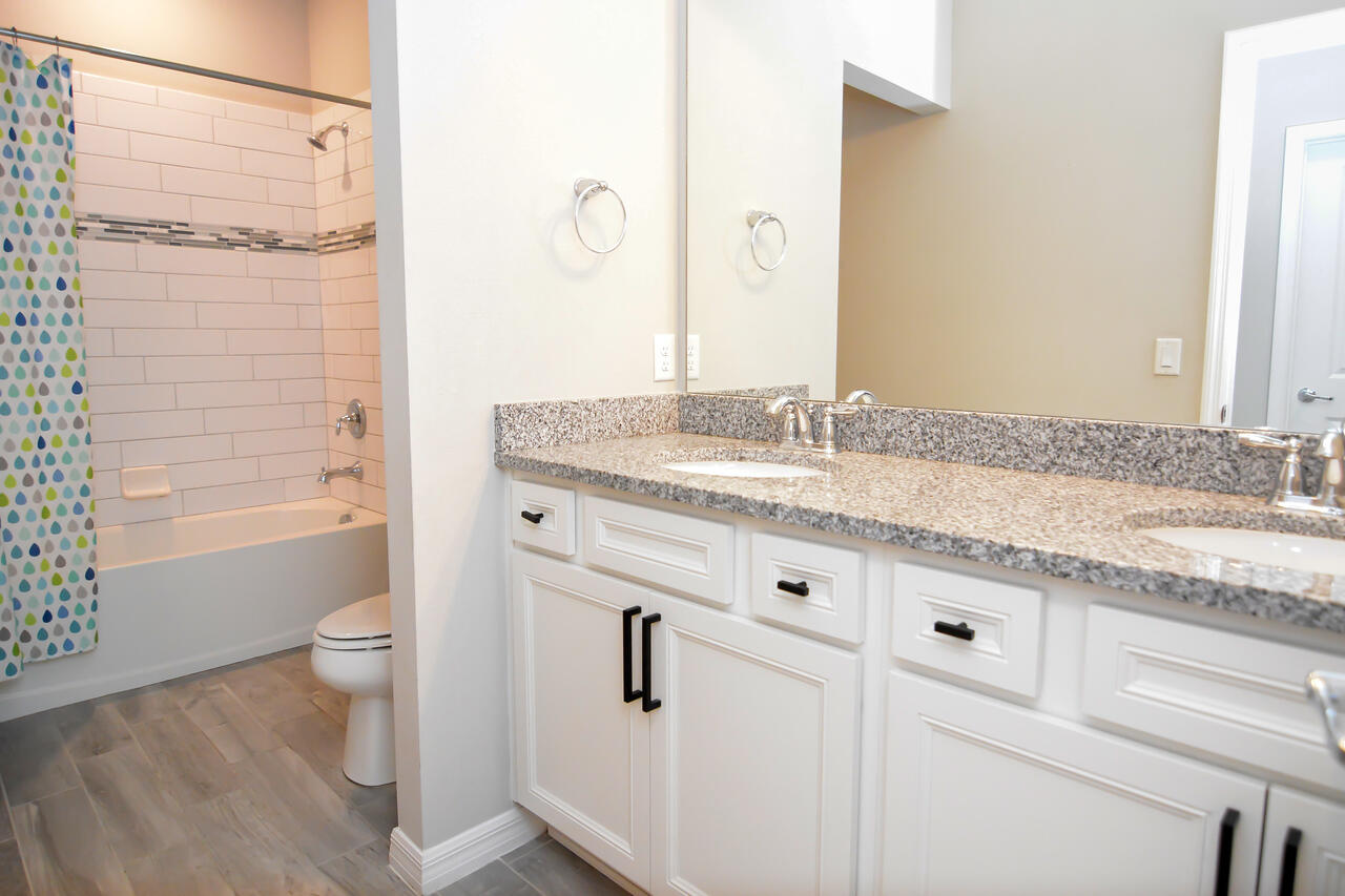 902 Foal Point Oviedo, FL 32765 - Photo 23 of 35 a bathroom with a granite countertop sink toilet and shower