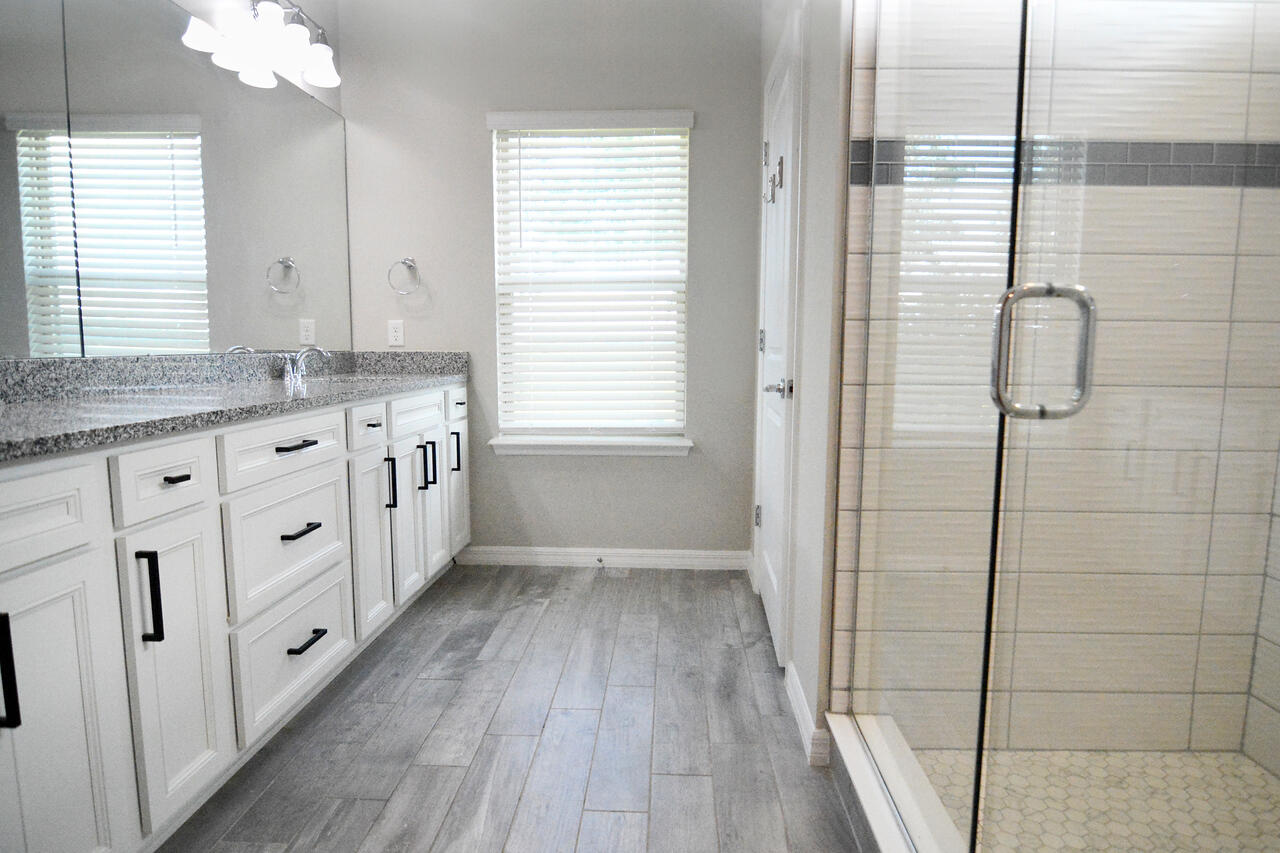 902 Foal Point Oviedo, FL 32765 - Photo 25 of 35 a bathroom with a granite countertop sink a toilet a mirror and shower