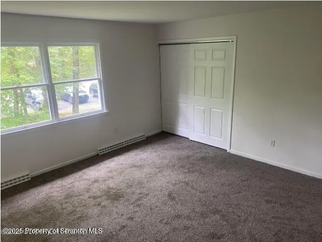 a view of an empty room and a window
