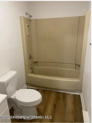 a white toilet sitting next to a bathroom sink