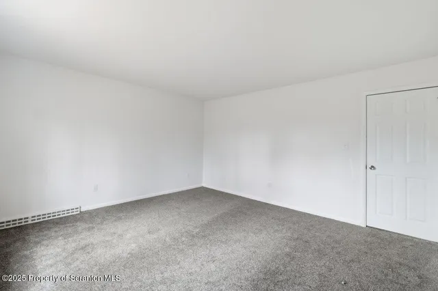 a view of an empty room with stairs