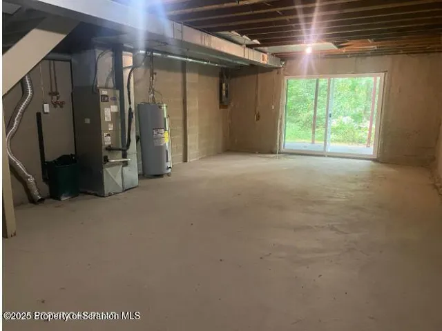 a view of a house with a yard and wooden fence