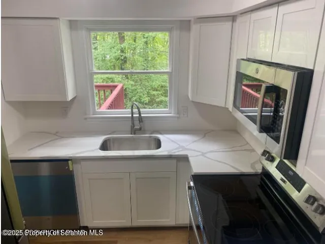 a kitchen with a sink stove and cabinets