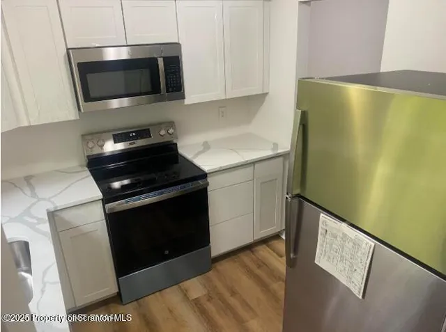 a kitchen with a microwave and a stove