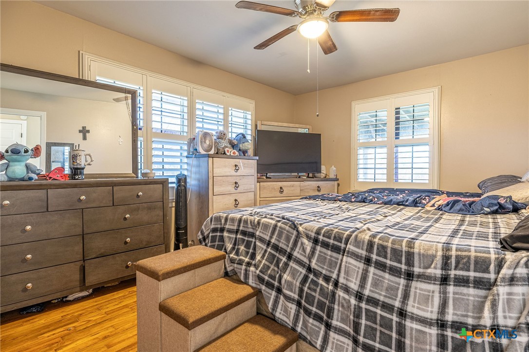 743 Royal Road Port Lavaca, TX 77979 - Photo 8 of 21 a bedroom with a bed and wooden floor
