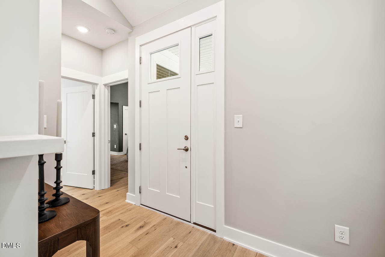 1905 Milan Street Durham, NC 27704 - Photo 15 of 42 a view of a hallway with wooden floor and a bathroom