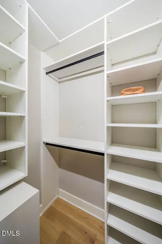 a view of walk in closet with empty racks