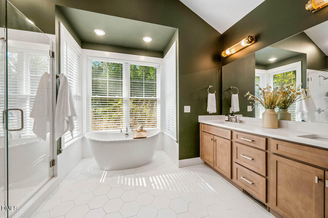 1905 Milan Street Durham, NC 27704 - Photo 20 of 42 a bathroom with a granite countertop sink mirror and bathtub