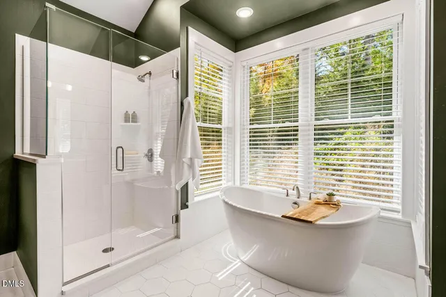 a bathroom with a granite countertop sink mirror and bathtub