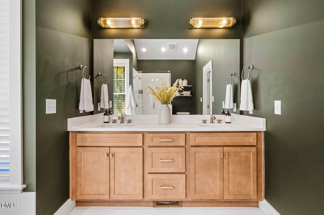 1905 Milan Street Durham, NC 27704 - Photo 22 of 42 a bathroom with a double vanity sink and a mirror